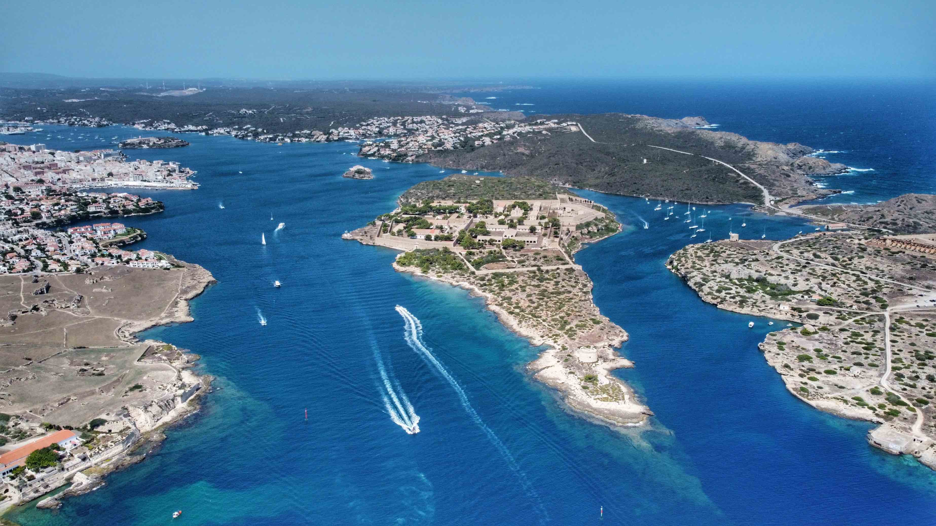 Private traditional Llaut boat sailing in Mahon harbor entrance Menorca